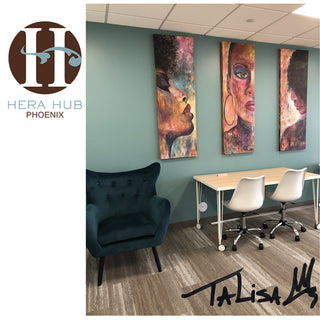 image of 3 large 20x60” each, statement piece paintings by TaLisa, on display at Hera Hub Phoenix. wall background is teal blue color, an office space environment with a table and chairs in view. 